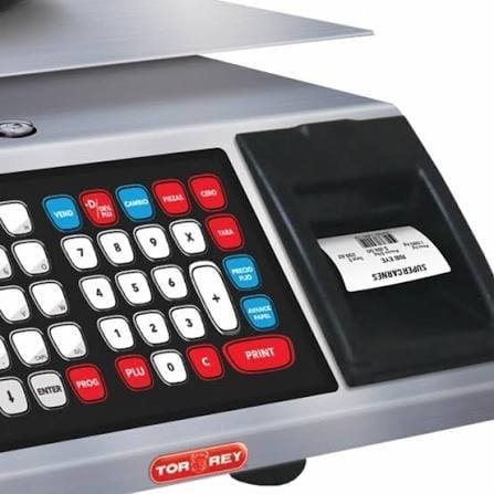Close-up of a Torrey scale with red, blue, and white function buttons and a label printer attached to the side